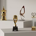 Gold And Crystal Trophies With Unique Designs And Black Bases On