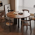 Modern Dining Space With Round Wooden Table Four Chairs Book Tray Bookshelf Artwork And Plant