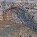 Steep Rock Cliff With Natural Textures And Sandy Ground Featuring Wooden Planks