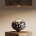 Blue and White Flower Vase With Black Abstract Patterns On Wooden Base Under Hanging Lighting