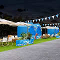 Scenic Outdoor Event Space With Triangular Tent Wooden Deck Tables Chairs Umbrellas And Grassy Area