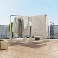 Modern Metal Clothes Rack With Hanging Garments And Green Plants On Terrace Wooden Floor
