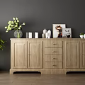 Wooden Sideboard with Vases Cups Artwork and Green Plant in Modern Interior