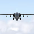 Military Camouflage Fighter Jet Flying Through Clouds With Weapon Pylons