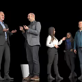 Group of Business People Standing and Conversing in Black Background Setting