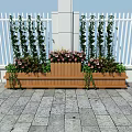 Decorative Garden Planters With Tall Green Plants Pink Flowers Against White Fence Stone Pavement
