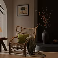 Rattan Leisure Chair Featuring Green Cushion Blanket And Side Table With Lamp Near Decorative Painting