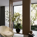 Indoor Potted Plant With White Flowers In Black Vase Near Beige Sofa And Large Window
