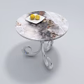 Round Marble Top Coffee Table with Silver Metal Legs and Two Lemons on White Plate