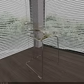 Transparent Glass Stool With Metal Legs In Room With Wooden Floor And Sunlight