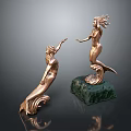 Two Golden Mermaid Sculptures With Intricate Details And Green Base Decoration