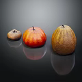 Three Fresh Vegetables in Brown Red Orange and Yellow on Black Reflective Surface with Reflections
