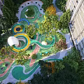 Colorful Outdoor Children's Playground With Circular Play Areas Slides And Green Trees
