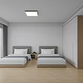 Hotel Guest Room With Two Beds Gray Headboards White Walls And Wooden Flooring