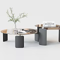 Modern Round Glass Top Coffee Table With Black Metal Legs And Decorative Books Vase