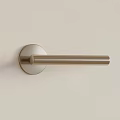 Modern Golden Door Handle With Sleek Design On Light Colored Door Surface