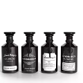 Elegant Perfume Cosmetics Collection With Four Black Glass Bottles And Brand Labels