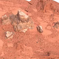 Red Desert Natural Landscape With Undulating Sandy Ground And Rock Formations