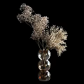 Brown Glass Vases With White Dried Flowers Against Dark Textured Wall And Small Lamp