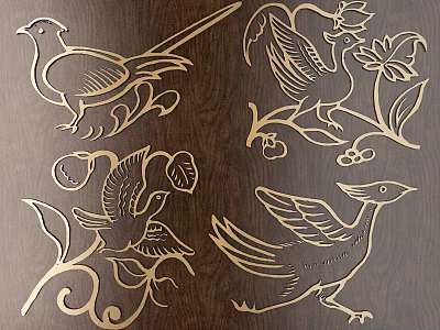 Intricate Golden Bird Carvings with Floral Patterns on Dark Wooden Surface 3d model