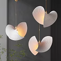 Modern Interior Space With Three White Scalloped Pendant Lights Emitting Warm Glow And Green Plants