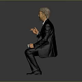Man Wearing Black Suit Holding White Cup Sitting Against Gray Background