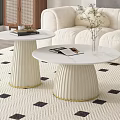 Stylish White Coffee Tables with Pleated Base Gold Trim and Magazines on Patterned Rug Featuring Flower Vase