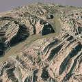Aerial View Of Mountainous Terrain With Winding River And Rugged Ranges