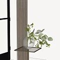 Glass Vase with Eucalyptus Branches and Small Green Berries on Gold Metal Side Table