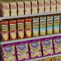 Multi Layered Metal Display Shelves With Various Canned Bottled And Boxed Products