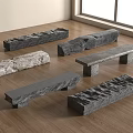 Different Textured Stone Benches Arranged On Wooden Floor With Natural Light