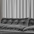 Neutral Toned Large Sofa in Living Room With Floor To Ceiling Curtains And Soft Rug