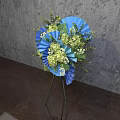 Blue Green Floral Arrangement With Fan Shaped Decor On Tripod Stand Grey Wall Wooden Floor
