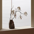 Minimalist Gray Stone Vase With Irregular Shape Holding Dried Branches On Windowsill By White Blinds