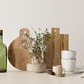 Kitchen Utensils Setup With Wooden Cutting Boards White Cups Plates Green Bottle And Small Plant