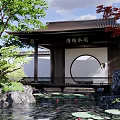 Traditional Chinese Garden Pavilion with Round Moon Gate Lush Greenery Rockery and Pond