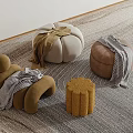 Stylish Modern Poufs In Various Shapes With Textured Covers On Woven Rug