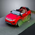 Red Convertible Toy Car With Steering Wheel Inspired By Land Rover On Green Mossy Ground