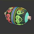 Green And Silver Decorative Container With Ornate Curved Patterns And Colorful Dots