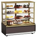 Various Decorated Cakes Displayed In Multi Shelf Glass Display Case