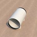 White Concrete Cylindrical Building Pipe With Black Rim And Small Block Supports On Brown Surface