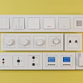 White Switch Panels With Various Types Buttons Knobs And Digital Displays On Yellow Background