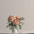 White Vase With Pink Hydrangeas And Green Leaves On Marble Tabletop In Light Background