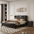 Modern Black Leather Double Bed With Floral Bedspread Nightstand And Decorative Paintings In Bedroom