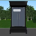 Black Glass Security Booth on Green Lawn with Trees and Bushes by Roadside