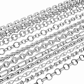Multiple Shiny Silver Metal Chains With Various Link Designs Arranged Neatly