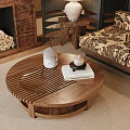 Round Wooden Coffee Table With Striped Design And Decorative Items In Living Room