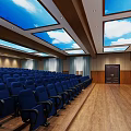 Modern Conference Room Interior With Blue Seats Wooden Floor Sky Cloud Ceiling Skylights Projection Screen