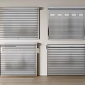 Four Gray Roller Blinds On White Wall With Light Wooden Floor And Green Plant