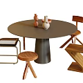 Round Dining Table Set With Dark Gray Top Black Legs Wooden Chairs And Decorative Items